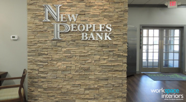 New Peoples Bank stone wall with metal signage