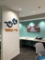 Dr. Brit E. Bowers, DDS pediatric dentistry patient check out area with branded signage wall