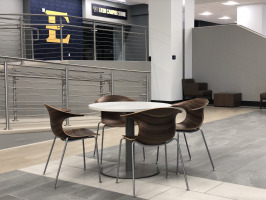 ETSU DP Culp Student Center food service area east entry dining tables and chairs with ETSU logo on wall