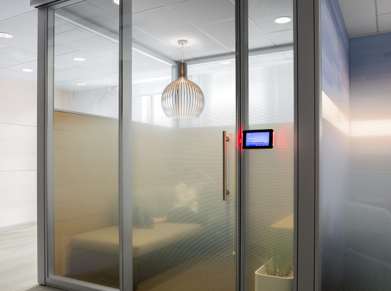 Private office with V.I.A. architectural walls by Steelcase and Casper Cloaking window frosting for privacy